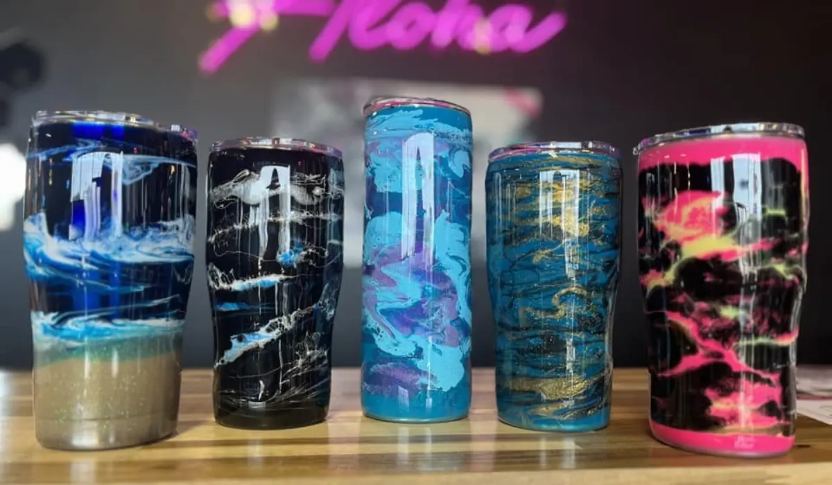 Five custom resin tumblers in blue, black, turquoise, gold, and pink at Hangout for Art