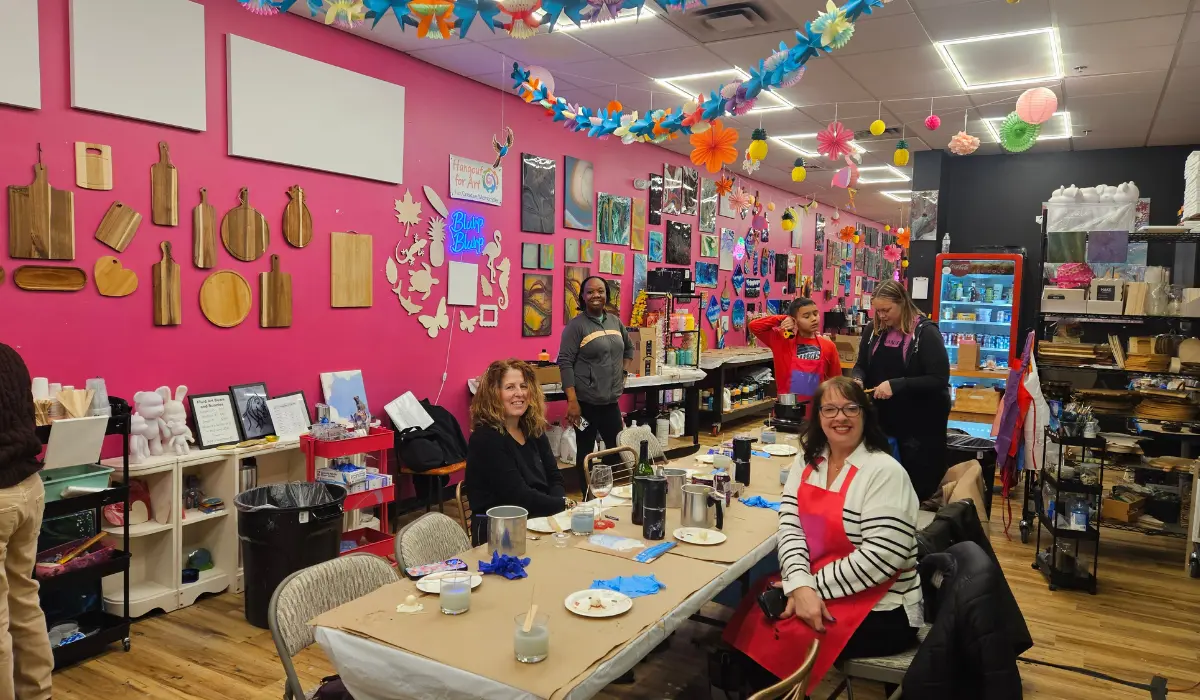 Diverse group creating art projects at tables in colorful Hangout for Art studio in Allentown