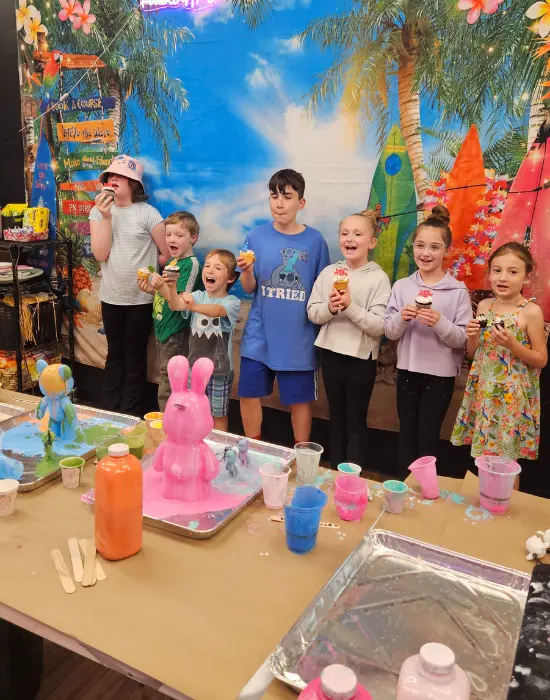 Group art experience with participants painting fluid art canvases in Allentown studio