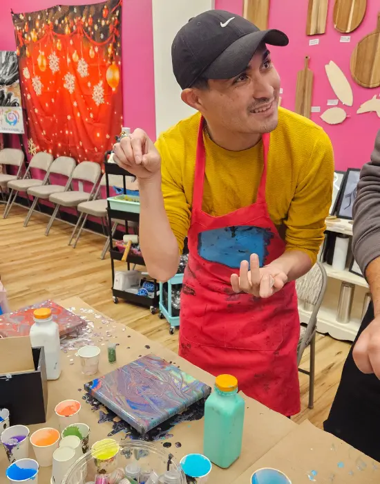 Corporate Team Building proudly holding completed fluid art canvas painting