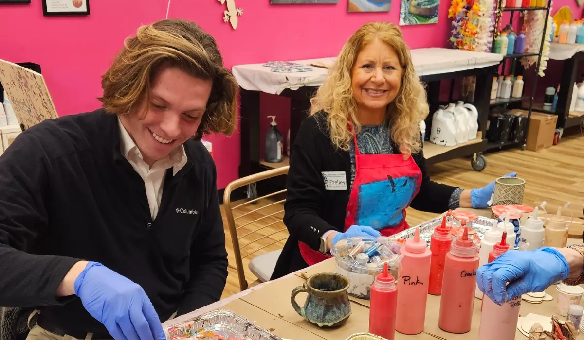 Two professionals creating resin art at networking event at Hangout for Art studio in Allentown