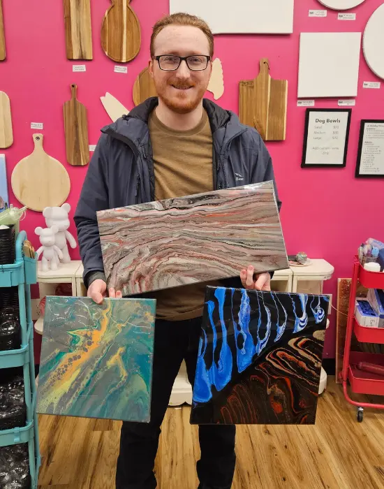 Resin Galaxy Scenes Customer proudly holding completed fluid art canvas painting