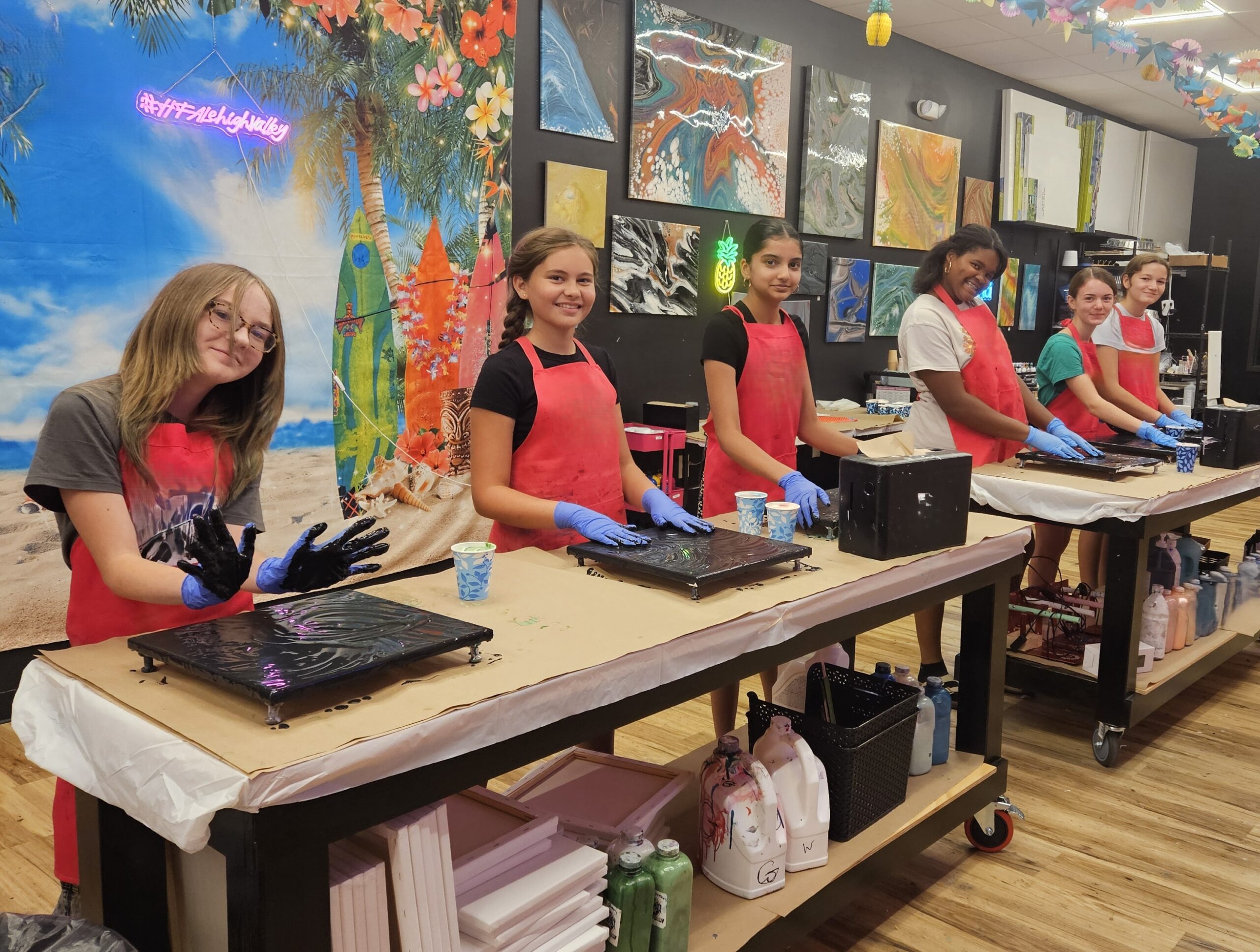 Smiling group creating fluid art together at Hangout for Art