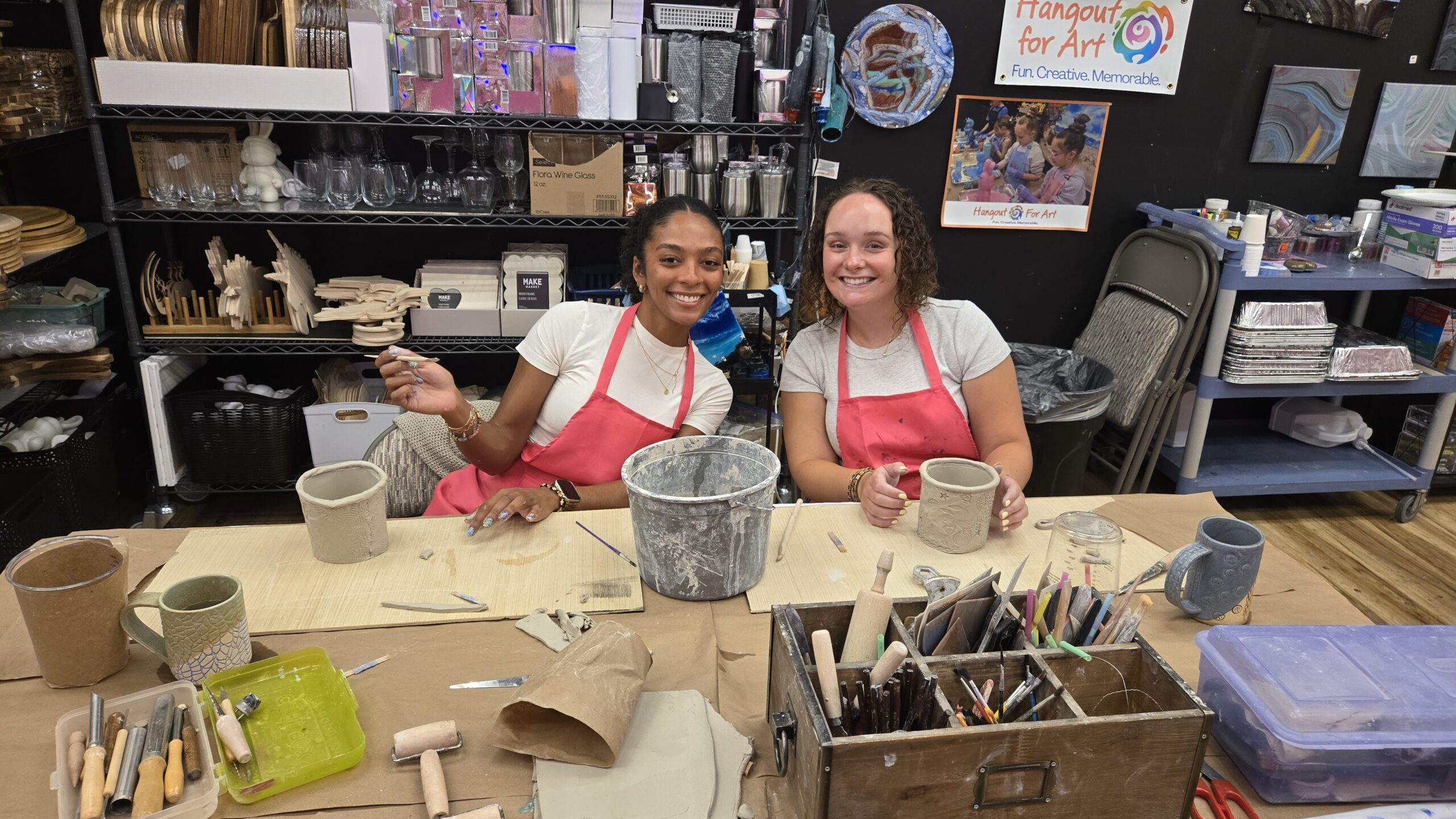 Women smiling while handbuilding stoneware clay flower pots at Hangout for Art